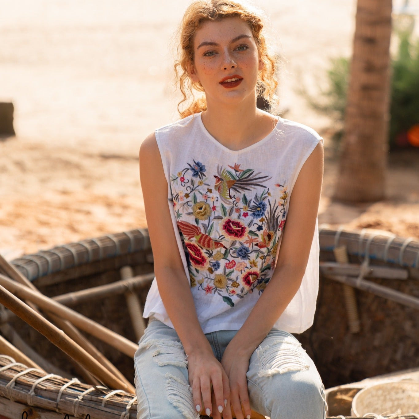 "Kai embroidered linen sleeveless top by Huulala, pink floral on white, artisan design"