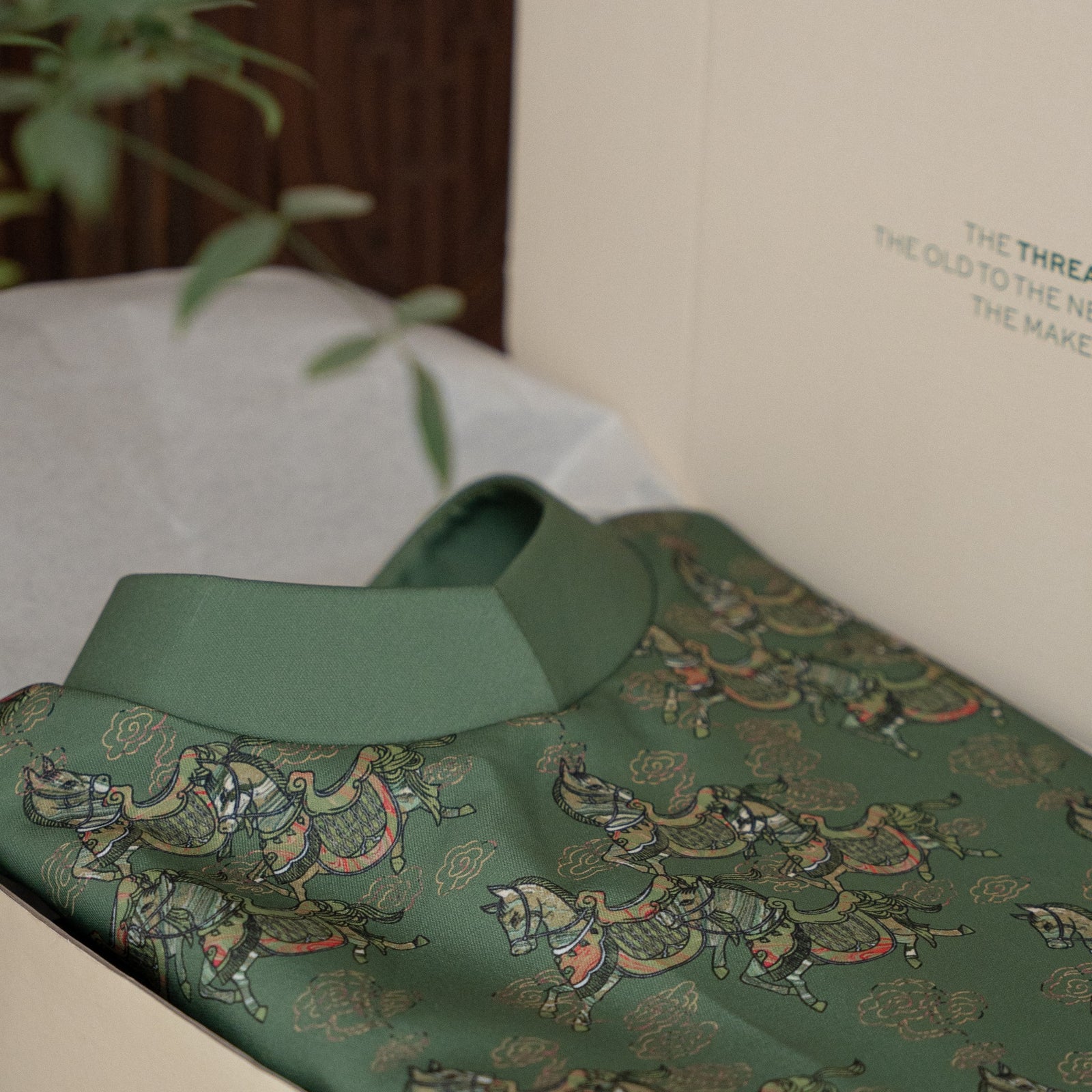 Vietnamese Embroidery - MÃ LỤC VÂN Men's Áo Dài - Printed Silk in Deep Jade Green - detail close-up in green by Maison LONG