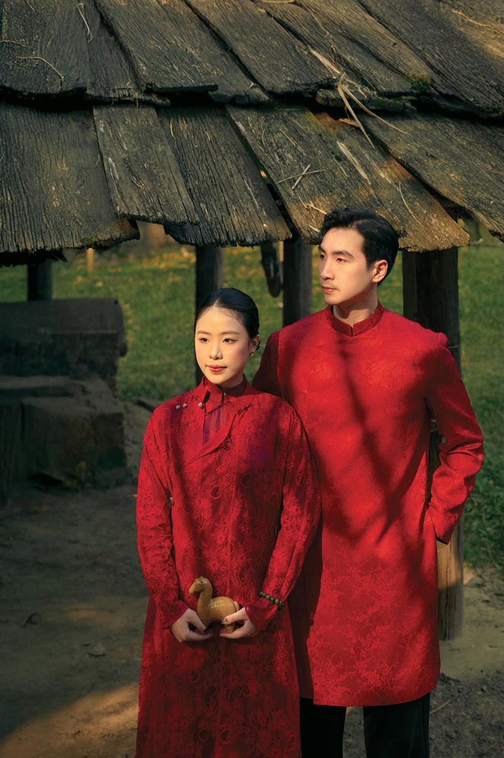 Phung Vân men's áo dài, lifestyle styled standing: traditional cut with balanced side slits