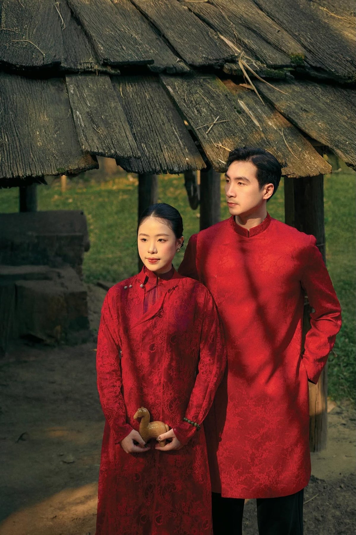 Phung Vân men's áo dài, lifestyle styled standing: traditional cut with balanced side slits