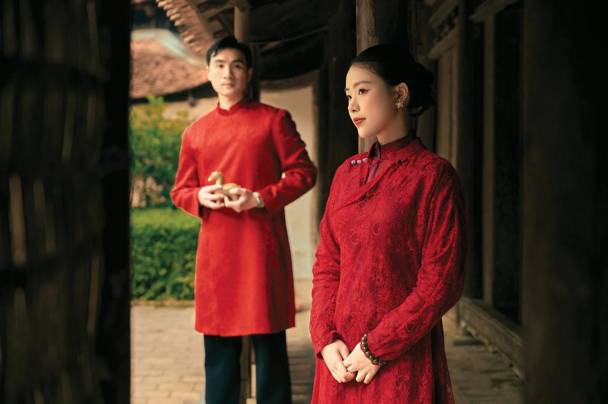 Phung Vân men's áo dài, lifestyle styled standing: crimson silk brocade for wedding and formal wear