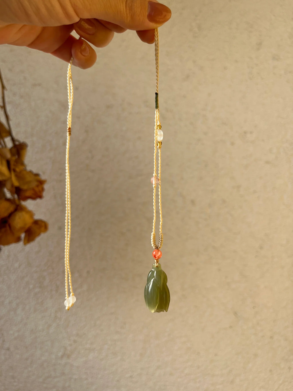 “Magnolia Dawn” - Hand Carved Light Green Hetian Jade Magnolia Pendant，手雕和田青黄口玉兰花 - detail close-up in gold by L'Orient Haus