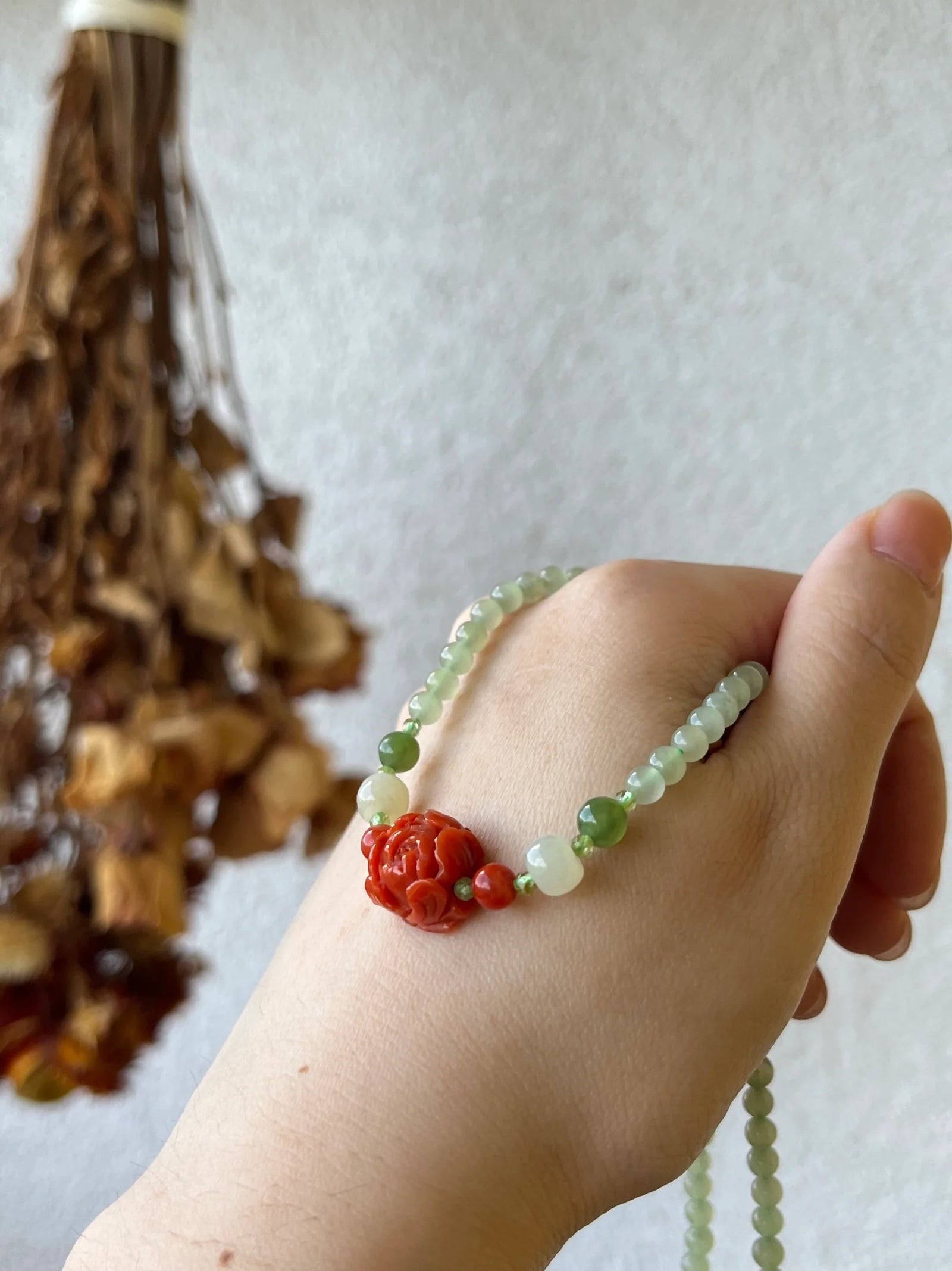 Traditional Motif - Peony Bloom - Nephrite & Nanhong Peony Necklace in tiny beads - worn presentation in red by L'Orient Haus
