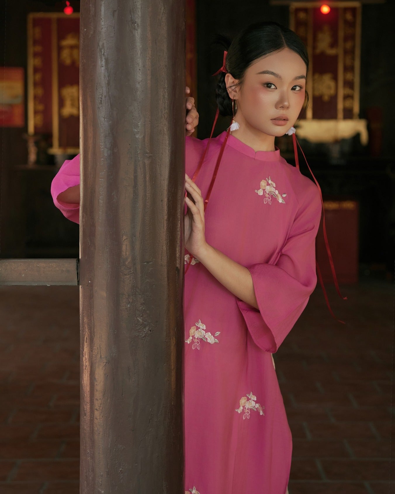 "Traditional Vietnamese Ao dai in pink chiffon with floral pattern, cultural authenticity."