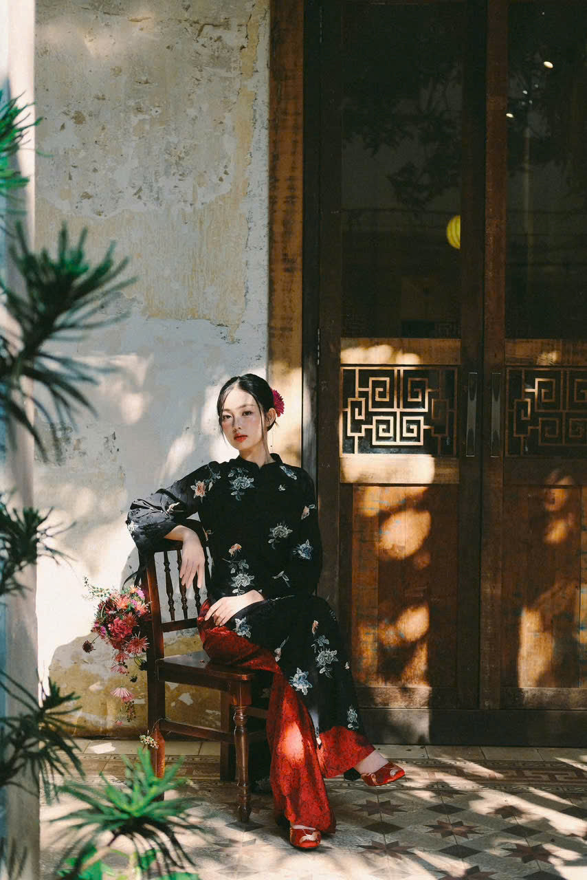 "Traditional Vietnamese Ao dai set in black silk with red floral embroidery, cultural attire"