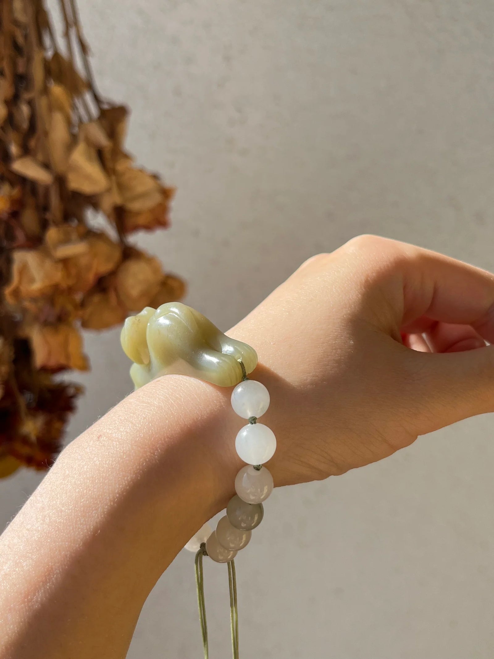 Traditional Motif - Fortune's Embrace – Nephrite Jade Lucky Cat Bracelet - worn presentation in green by L'Orient Haus