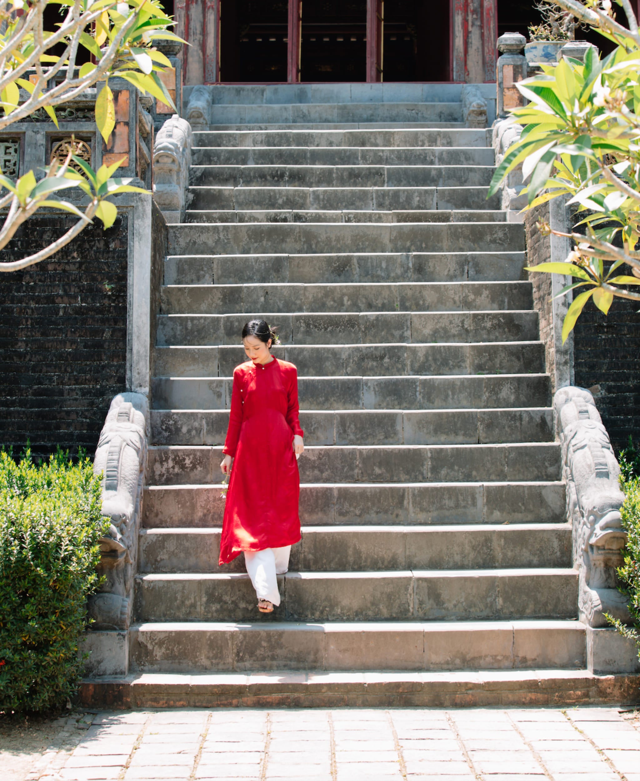"Traditional Vietnamese Ao Dai set 'Ngu Than' in red silkworm silk by Moc, featuring artisan woven patterns."