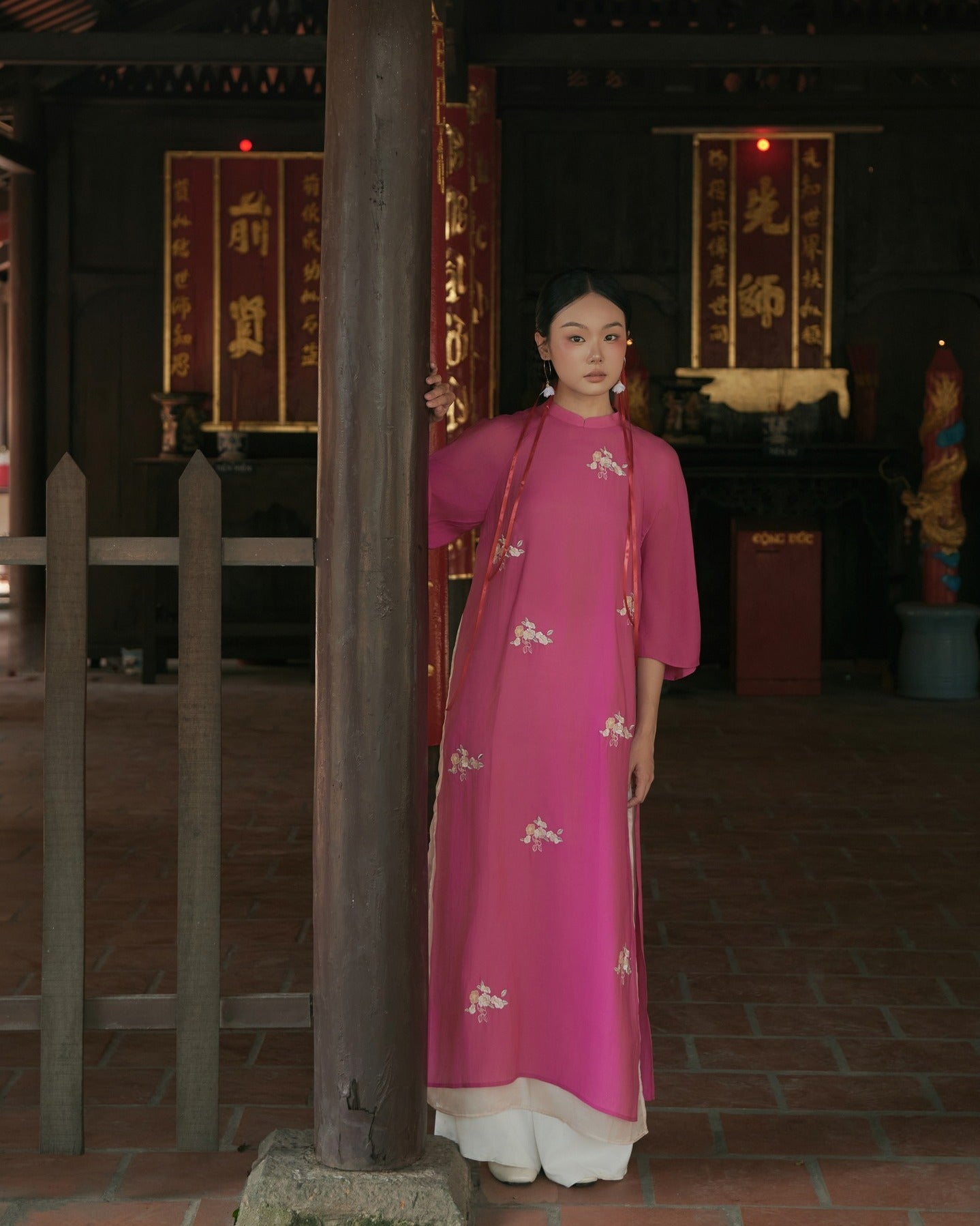 "Traditional Vietnamese Ao dai in pink chiffon with floral pattern, artisan silk design"