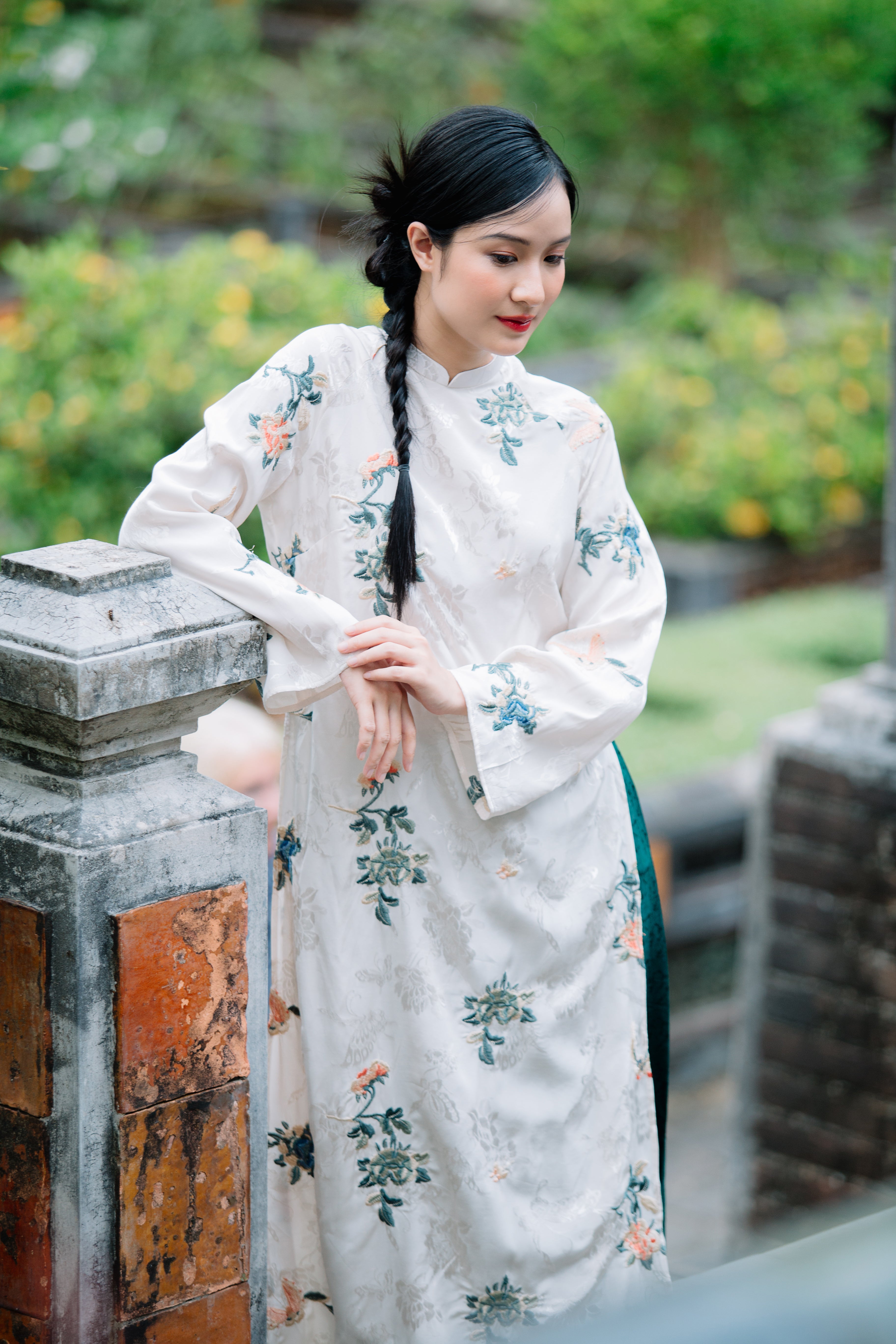 Woman in a floral-patterned dress stands