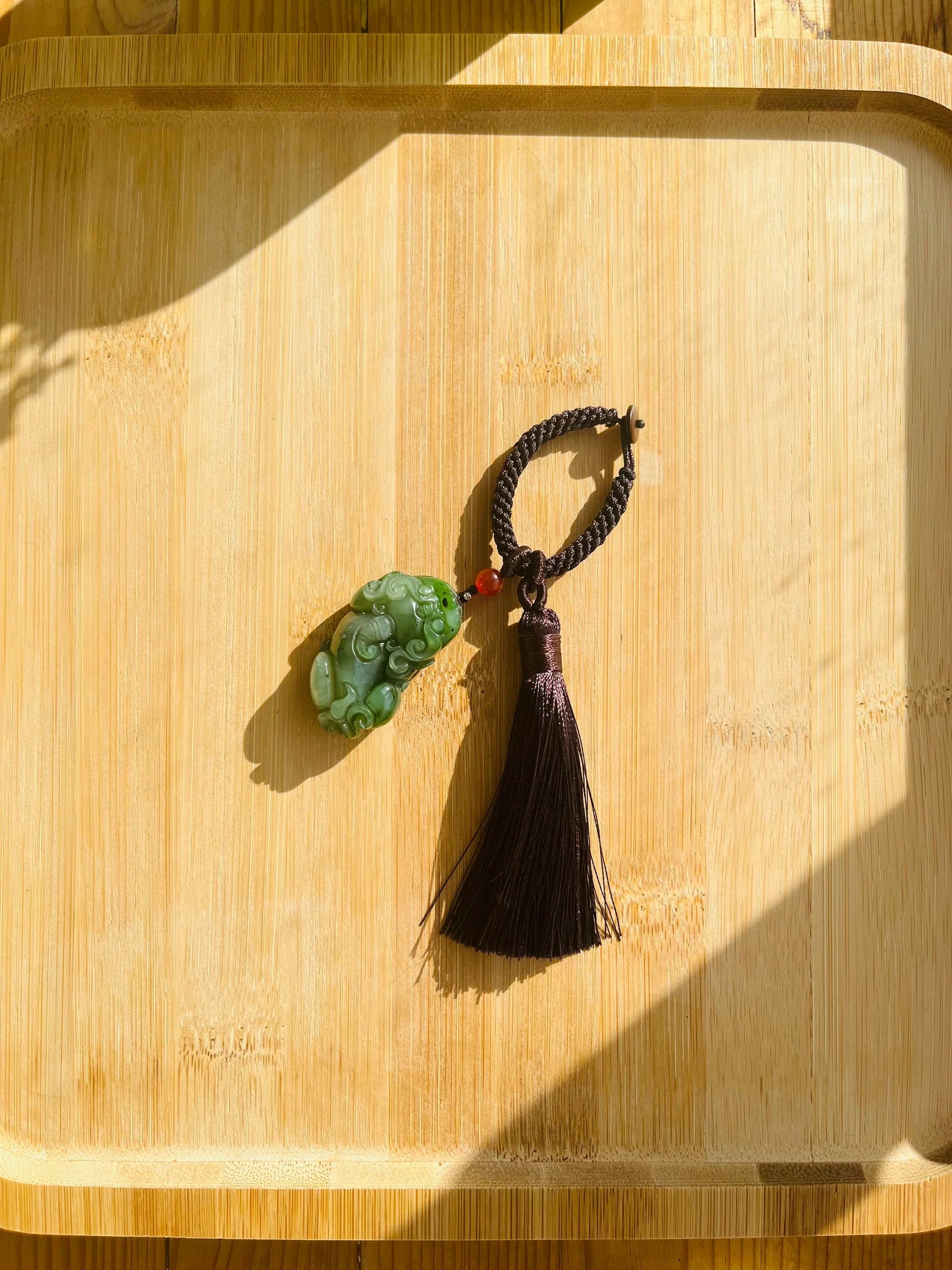 Fortune Fang - Key Chain/Bag Charm with a Carved Green Hetian Jade Pixiu - flat lay display in green by L'Orient Haus