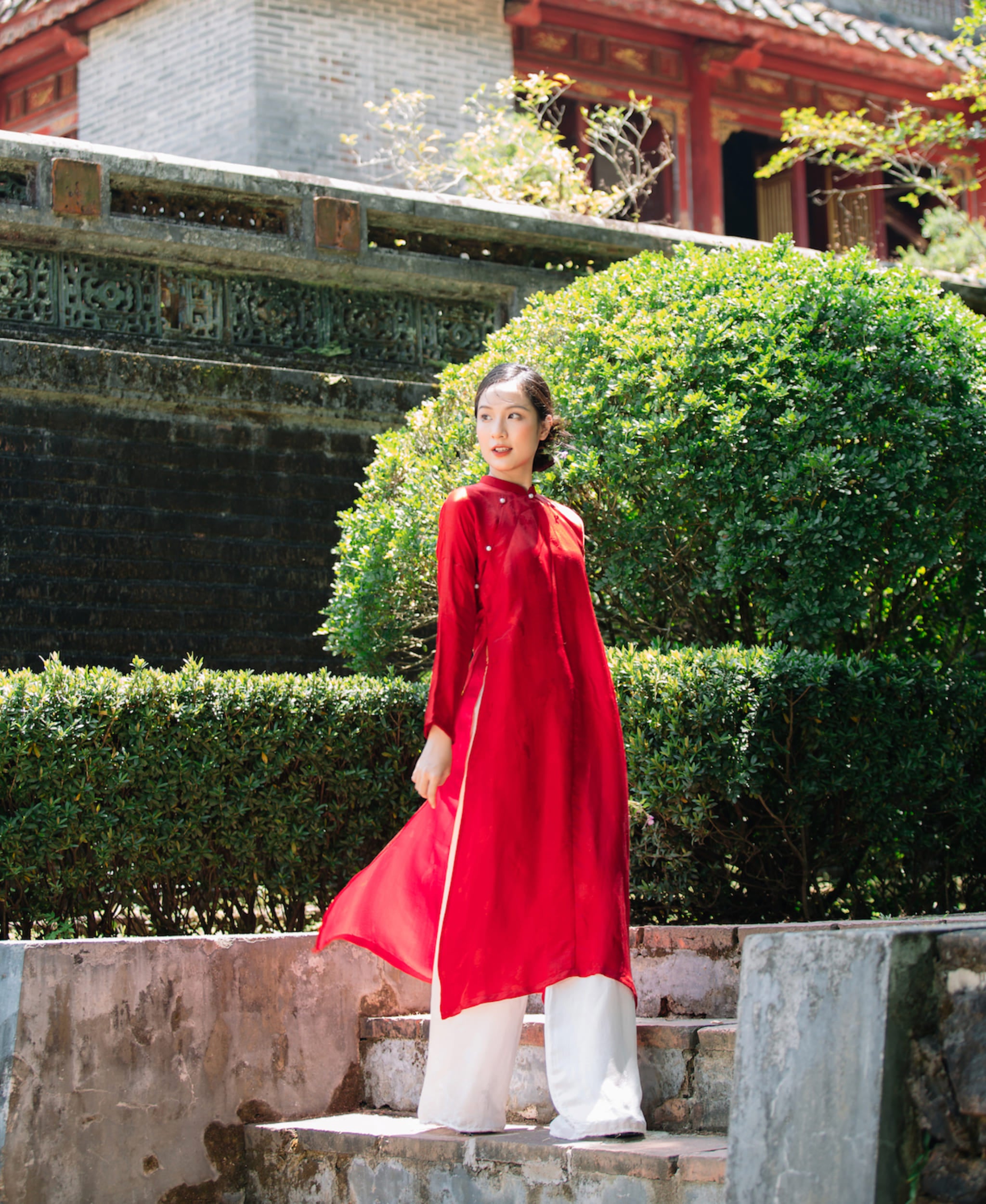 "Traditional Vietnamese 'Ngu Than' Ao Dai set in red silkworm silk by Moc, featuring artisan woven design."