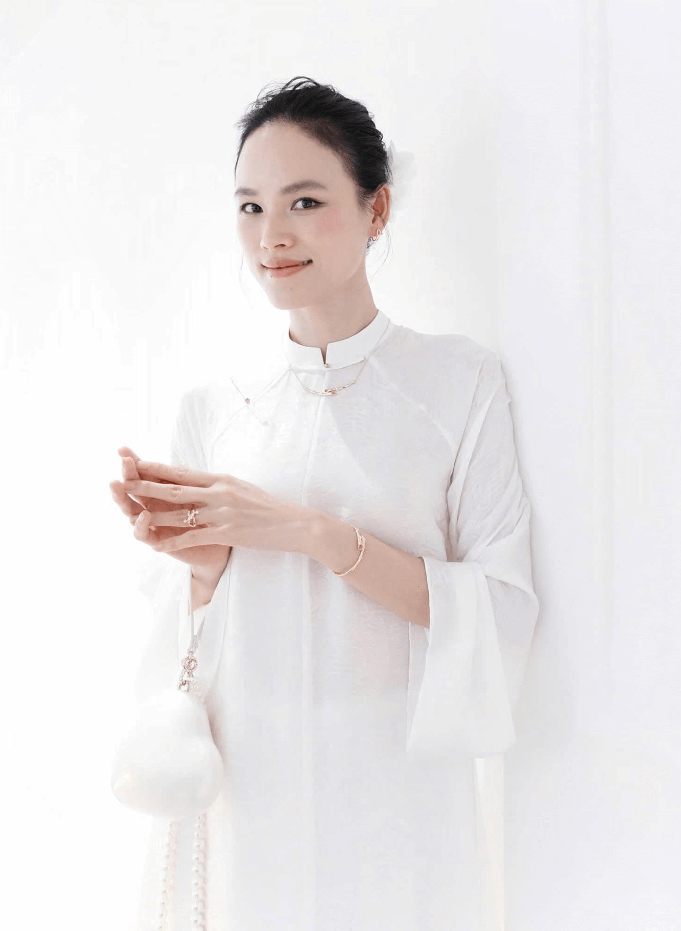 "Hy Loan Ao Dai Set in white silk by Lalin, traditional Vietnamese dress with modern design."