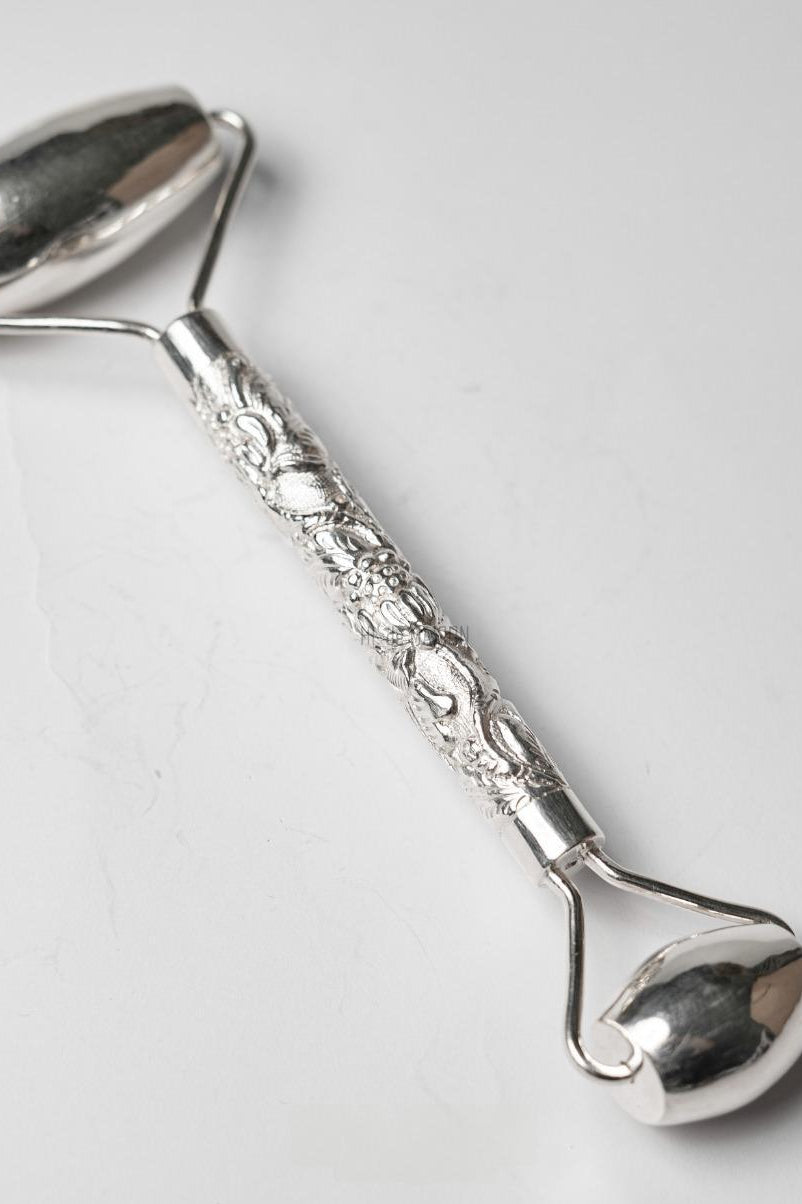 Tĩnh Liên 99.9% fine silver facial massage roller with hand-engraved wave and petal motifs by HI de Maison Vietnamese silversmith