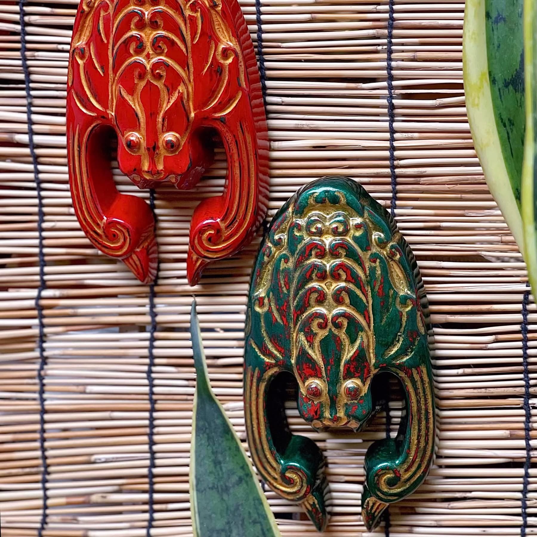 "Phuc Dao Tien Mon" - Traditional Vietnamese artisan door charm in red and green with intricate patterns.
