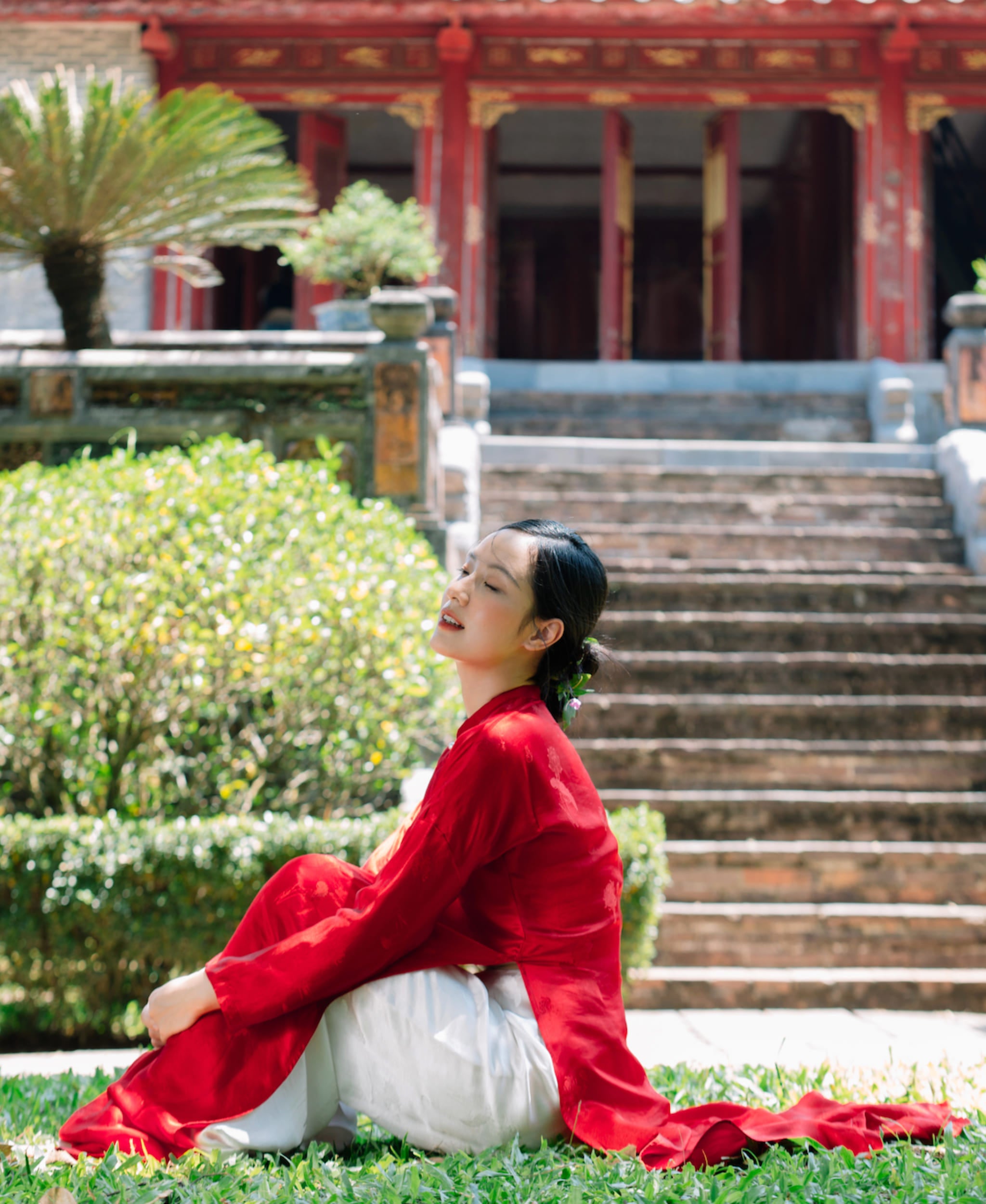 "Traditional Vietnamese 'Ngu Than' Ao Dai set in red silkworm silk by Moc, featuring artisan woven design."