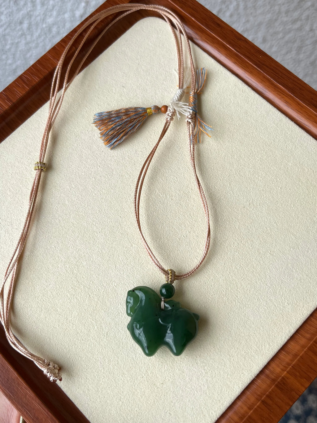 Gallant Spirit – Hand-Carved Hetian Jade Horse Charm - flat lay display in silk in green by L'Orient Haus