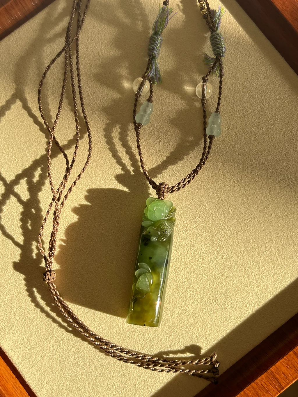 “Song of the Lotus” - Hand Carved Green Hetian Jade Lotus and Magpie Pendant | 手雕和田碧玉喜鹊荷花吊坠 - flat lay display
