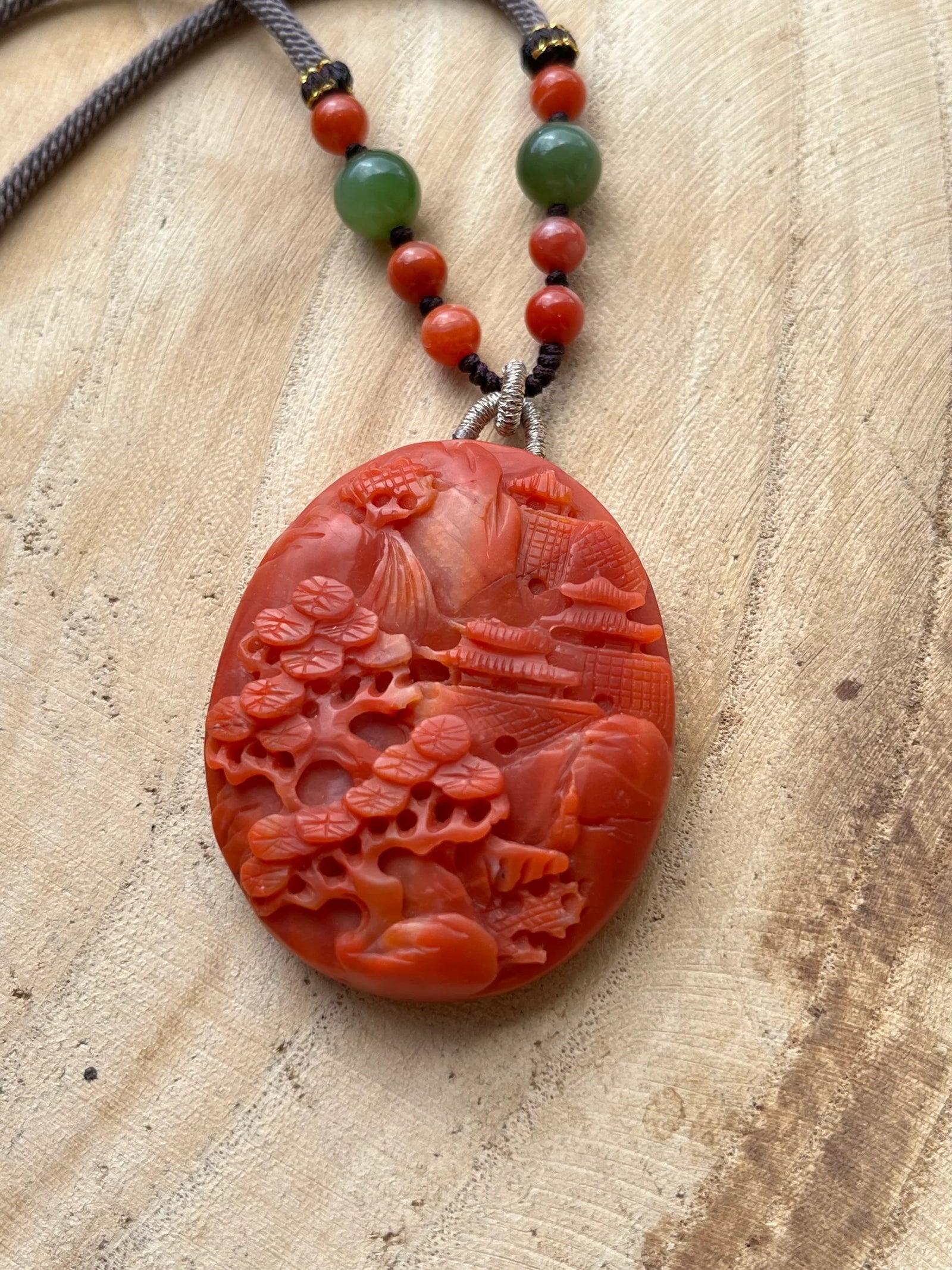 “Crimson Horizon” - Necklace with a Hand Carved Nanhong Agate Landscape Pendant, 手雕南红山水 - flat lay display by L'Orient Haus