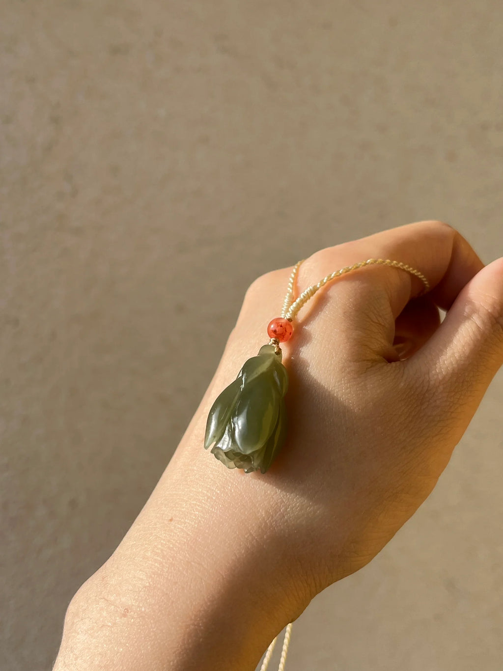 “Magnolia Dawn” - Hand Carved Light Green Hetian Jade Magnolia Pendant，手雕和田青黄口玉兰花 - detail close-up in green by L'Orient Haus