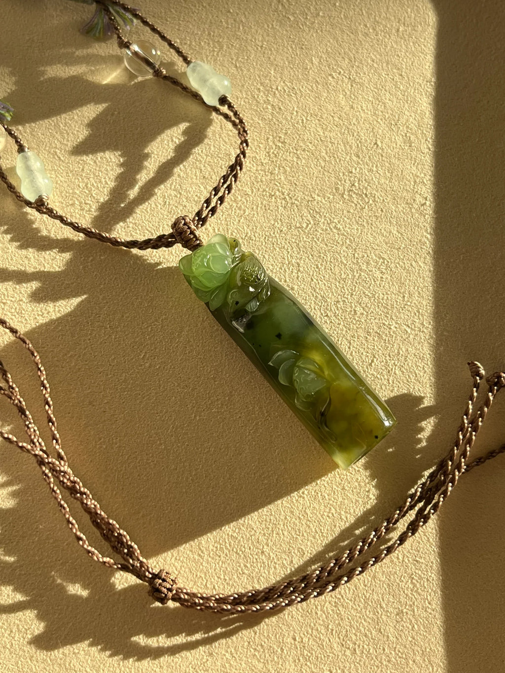 “Song of the Lotus” - Hand Carved Green Hetian Jade Lotus and Magpie Pendant | 手雕和田碧玉喜鹊荷花吊坠 - flat lay display