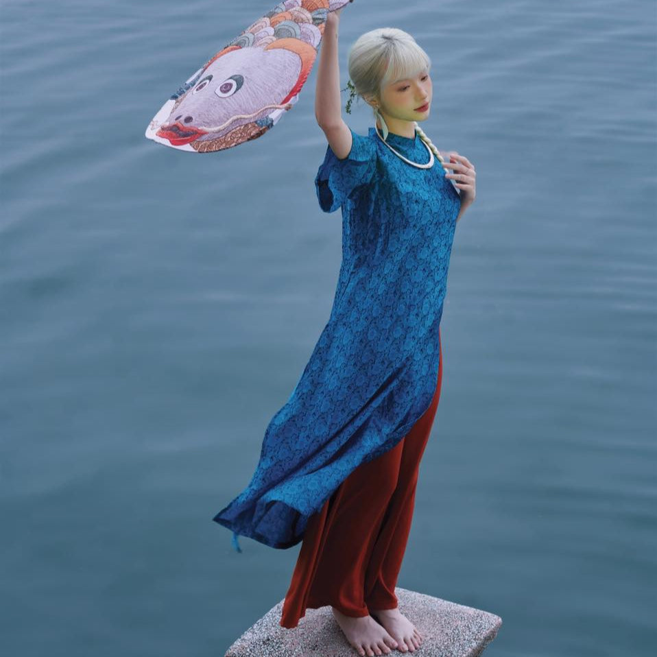 "Cuc Hoa Ao Dai set in blue silk and red pants, traditional Vietnamese dress by Moc."