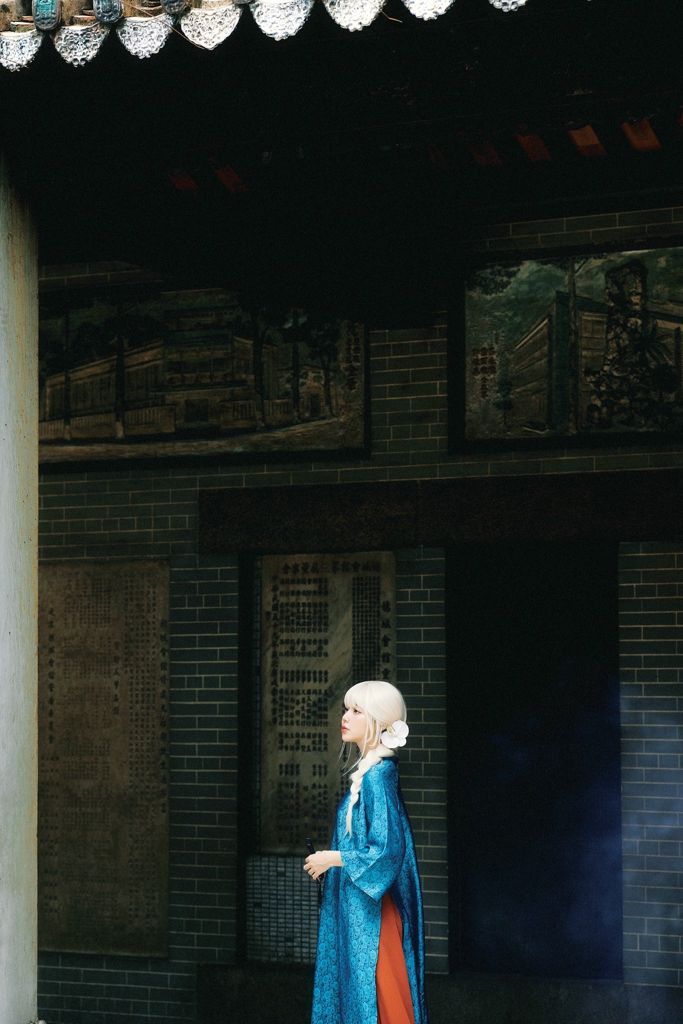 "Traditional Vietnamese 'Cuc Hoa' Ao Dai set in sapphire wormsilk, featuring red and blue artisan jacquard design."