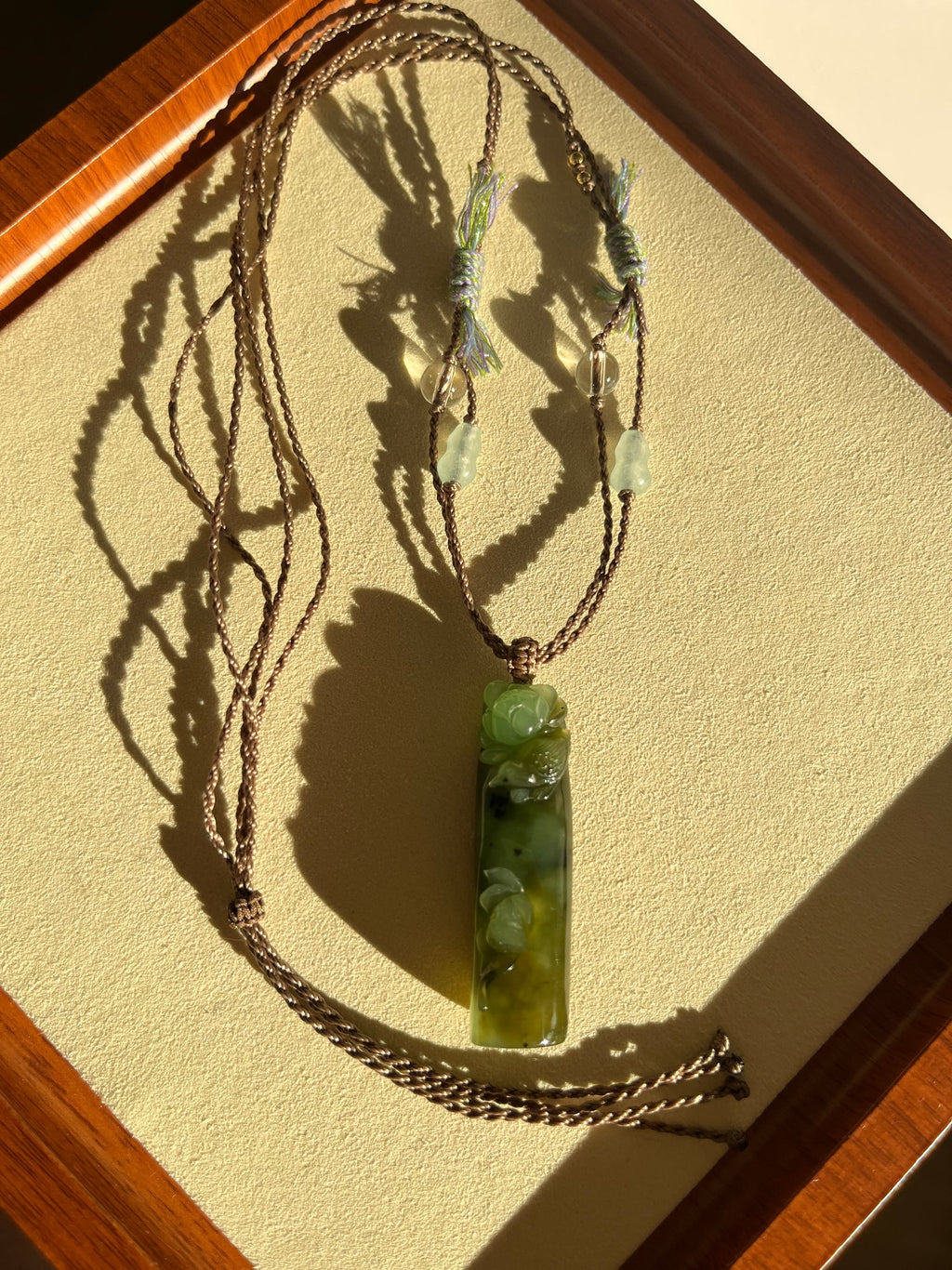 “Song of the Lotus” - Hand Carved Green Hetian Jade Lotus and Magpie Pendant | 手雕和田碧玉喜鹊荷花吊坠 - flat lay display