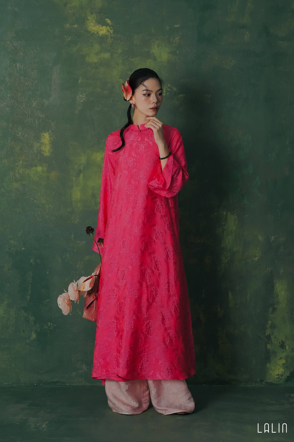 "Diep Dan Ao Dai Set in bright peach silk by Lalin, traditional Vietnamese dress with modern artisan patterns."