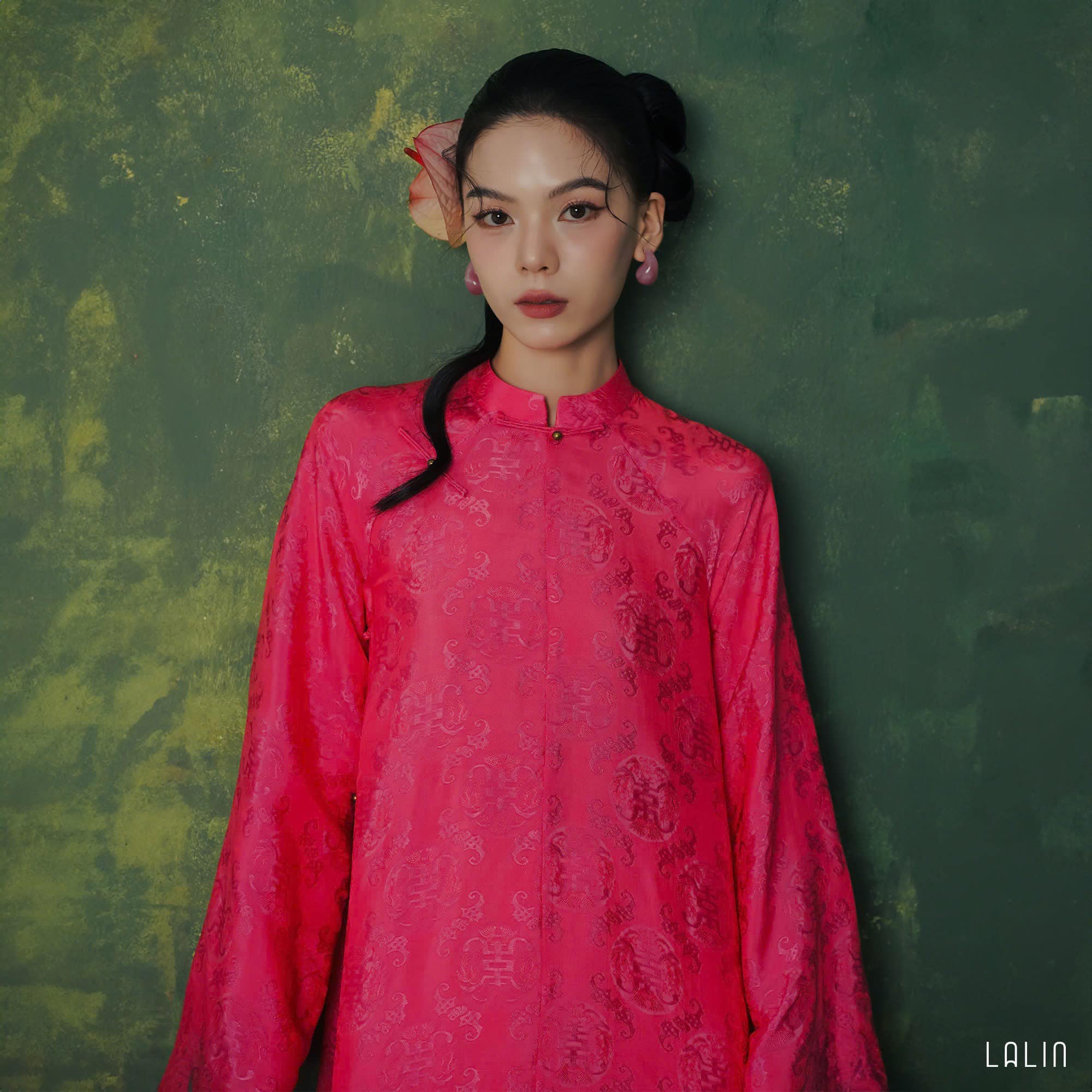 "Diep Dan Ao Dai Set in bright peach silk by Lalin, traditional Vietnamese dress with modern patterns."
