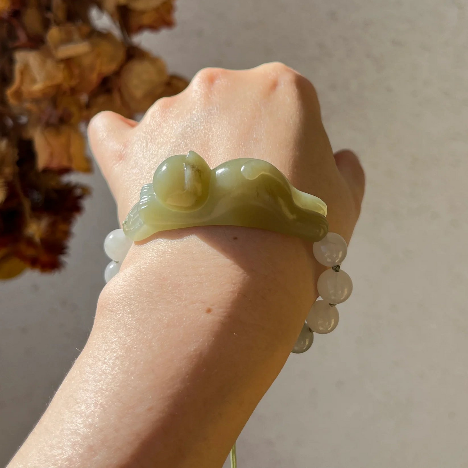 Traditional Motif - Fortune's Embrace – Nephrite Jade Lucky Cat Bracelet - worn presentation in green by L'Orient Haus