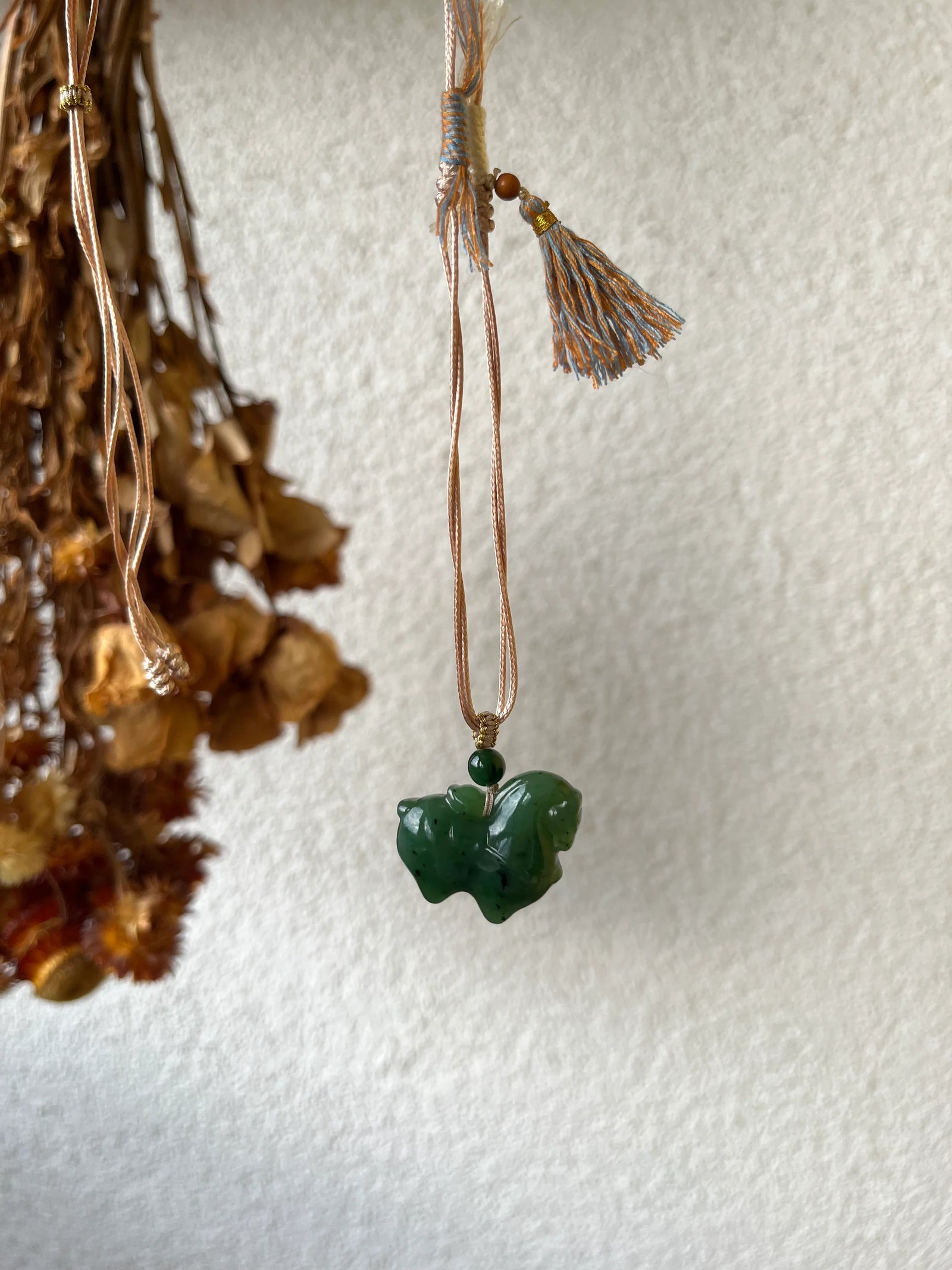 Gallant Spirit – Hand-Carved Hetian Jade Horse Charm - detail close-up in silk in green by L'Orient Haus