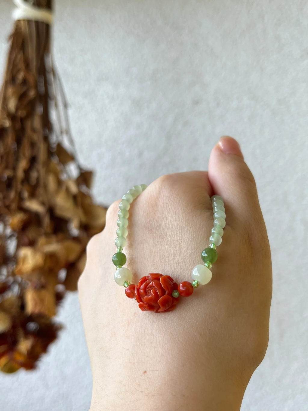 Traditional Motif - Peony Bloom - Nephrite & Nanhong Peony Necklace in tiny beads - worn presentation in red by L'Orient Haus