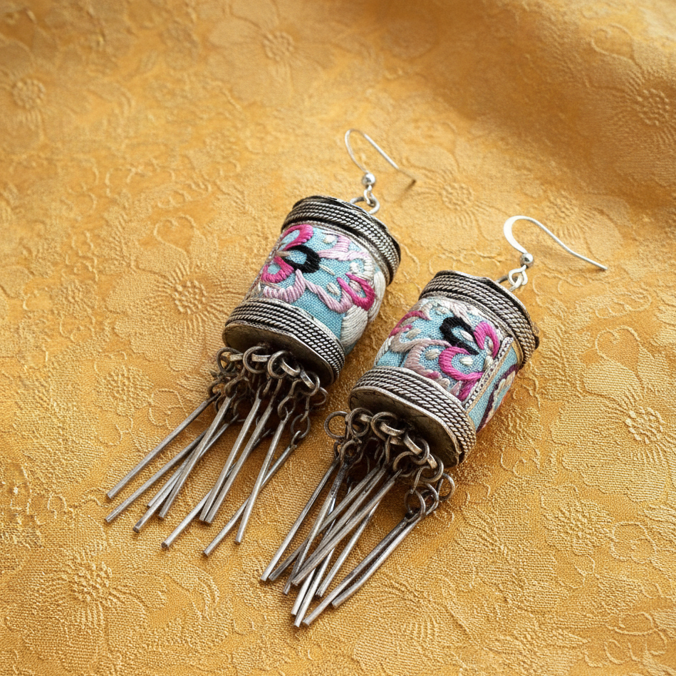 Close-up of Bloom handcrafted embroidered earrings showing traditional Miao patterns
