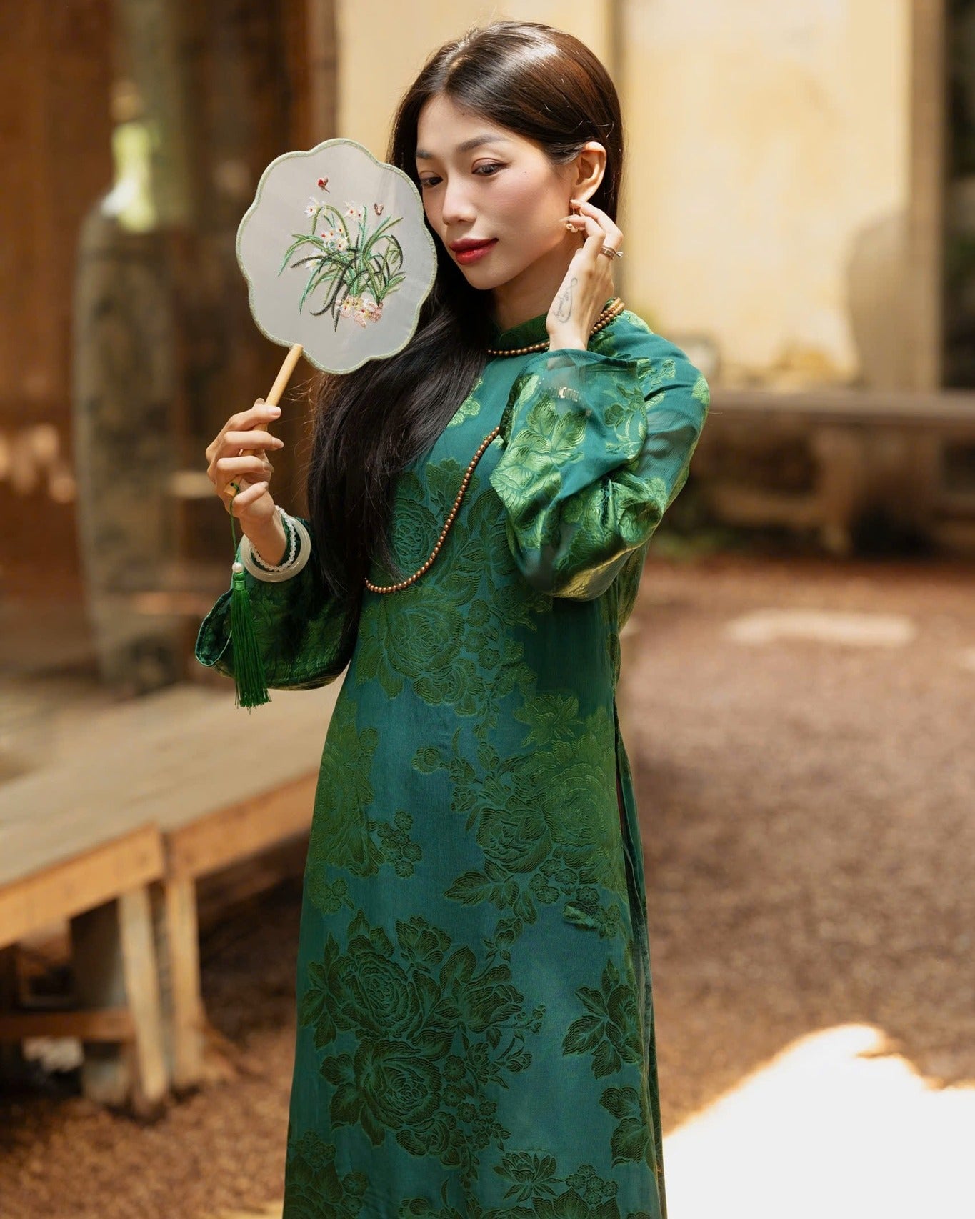 "Elegant 'Giai Nhan' Ao Dai set in green wormsilk with floral patterns, traditional Vietnamese dress by Moc."