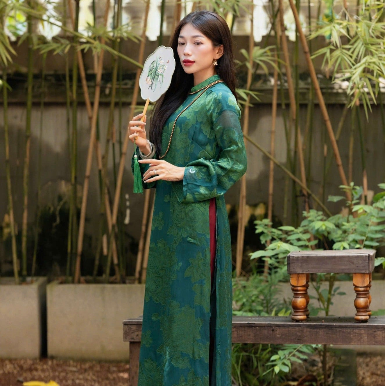 "Traditional Vietnamese Ao Dai in green silk with floral patterns, 'Giai Nhan' by Moc, cultural heritage dress"