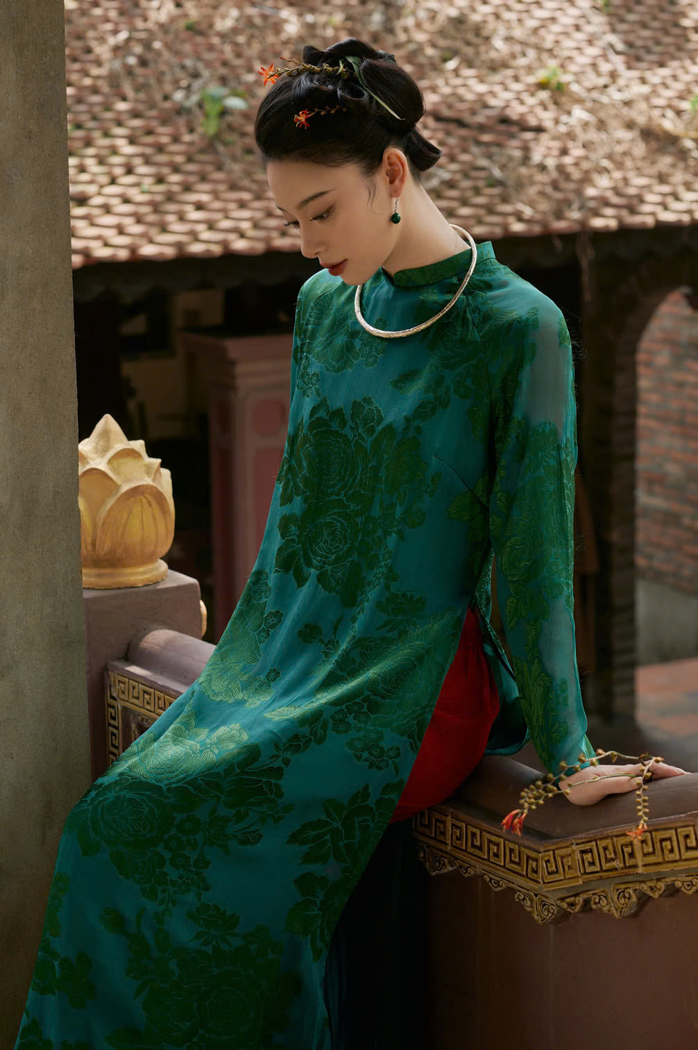 "Traditional Vietnamese Ao Dai in green flowery silk by Moc, showcasing cultural heritage."
