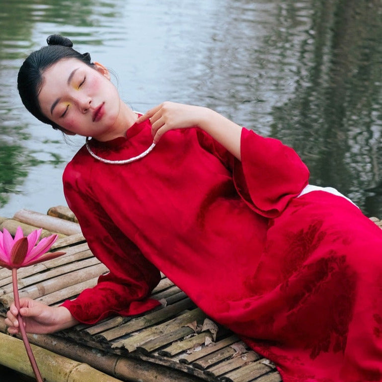 "Traditional Vietnamese Ao Dai in crimson silk, artisan-crafted with cultural authenticity."