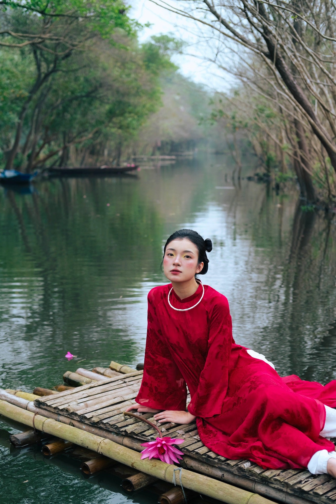 "Traditional Vietnamese Ao dai in crimson silk, artisan-crafted with flowery design, cultural heritage attire."