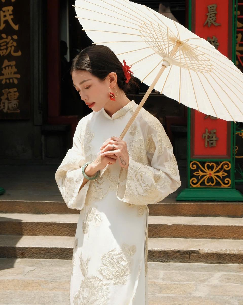 "Giai Nhan Premium Ao Dai set in white silk with floral embroidery, traditional Vietnamese dress."