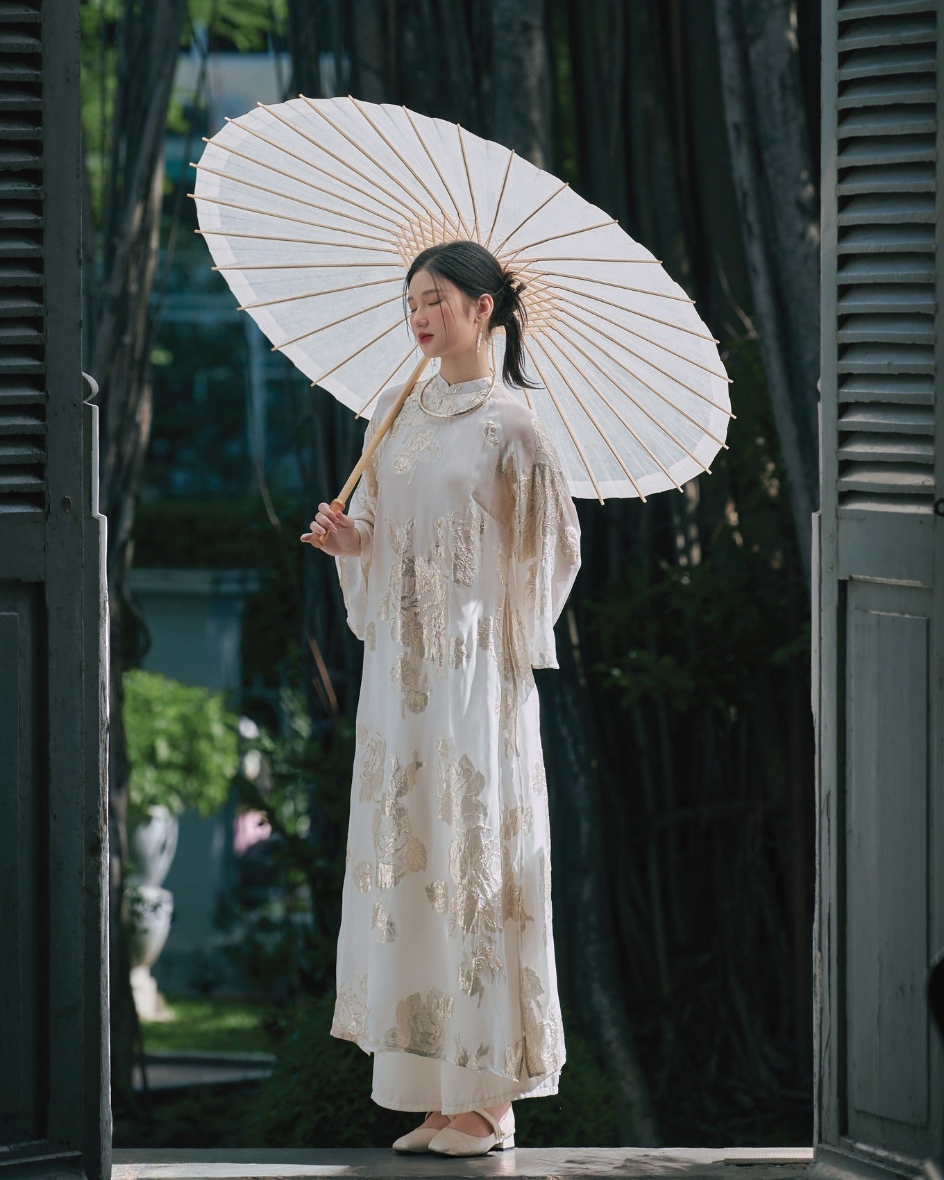 "Giai Nhan Premium Ao Dai set in white silk with flowery patterns, traditional Vietnamese dress by Moc."