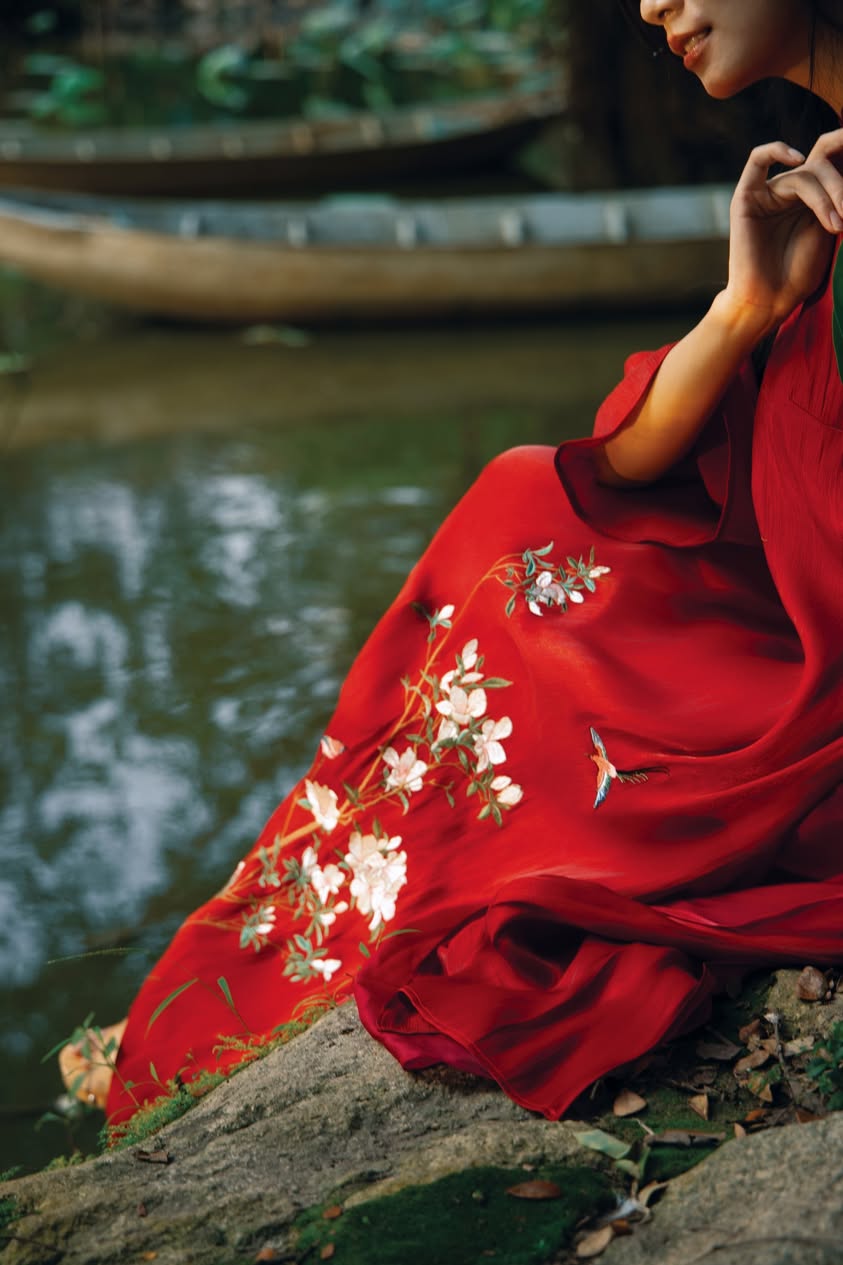 "Traditional Vietnamese Ao dai in red silk with artisan floral embroidery, cultural authenticity"