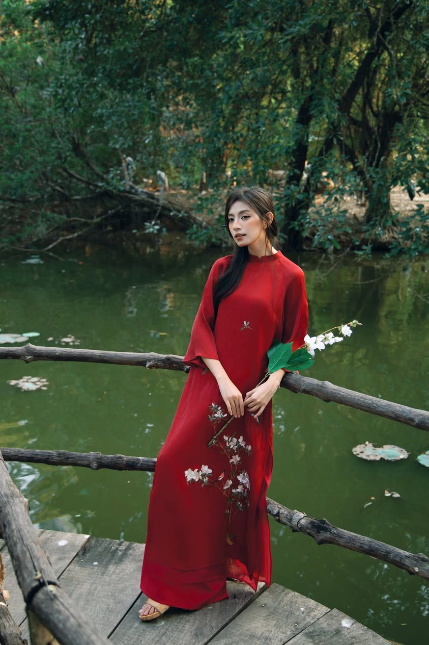 "Red silk 'Giao Mien' Ao Dai with floral embroidery, traditional Vietnamese dress by Moc."
