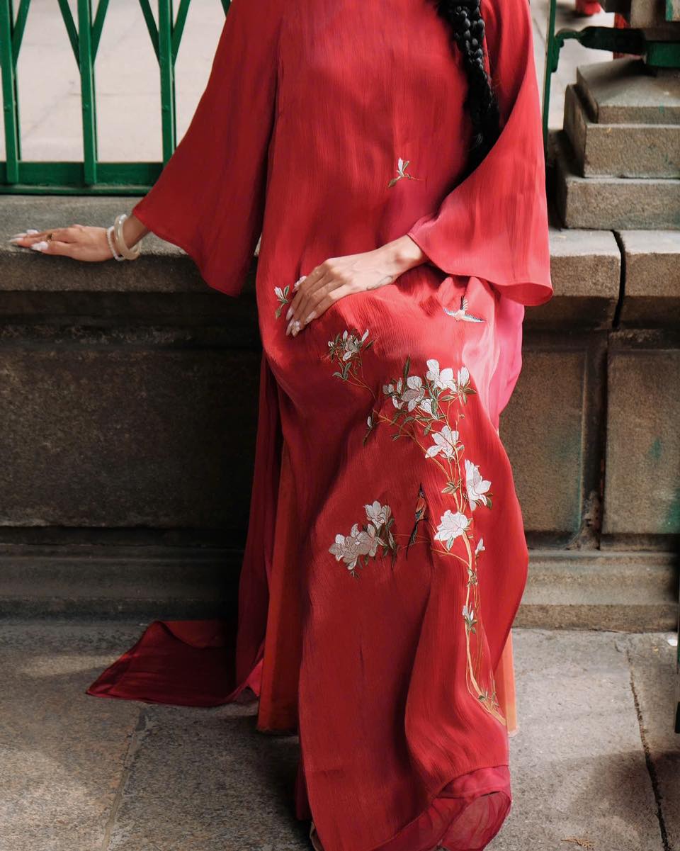 "Red silk Ao dai with floral embroidery, traditional Vietnamese dress by Moc."