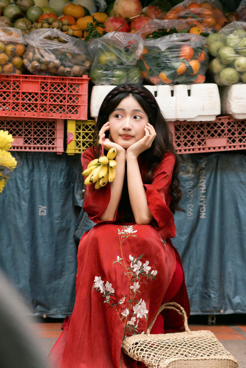 "Red silk 'Giao Mien' Ao Dai with floral embroidery, traditional Vietnamese dress by Moc."