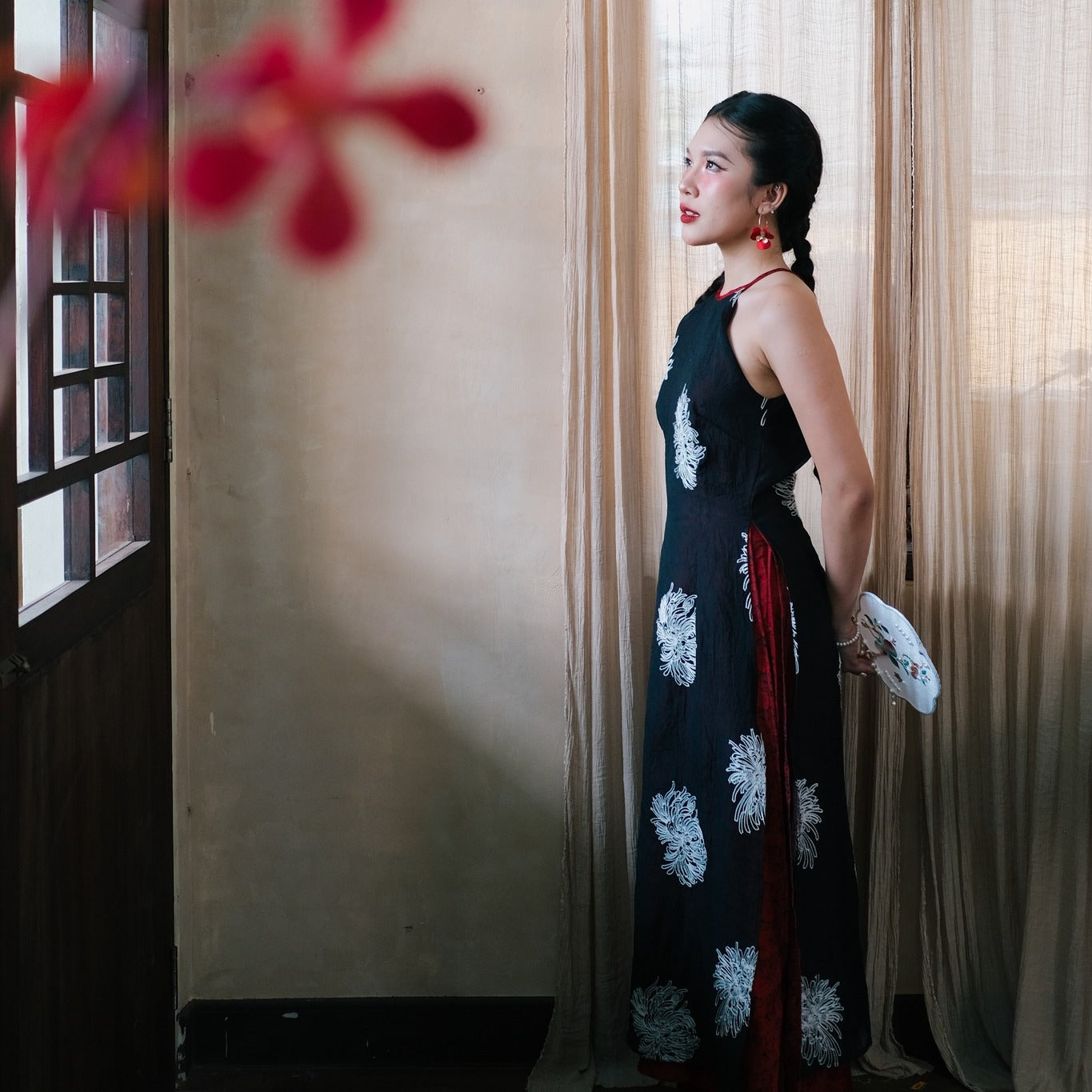 "Traditional Vietnamese Ao dai 'Giac Mong Dem He' in black silk with embroidered flowers, artisan-crafted."