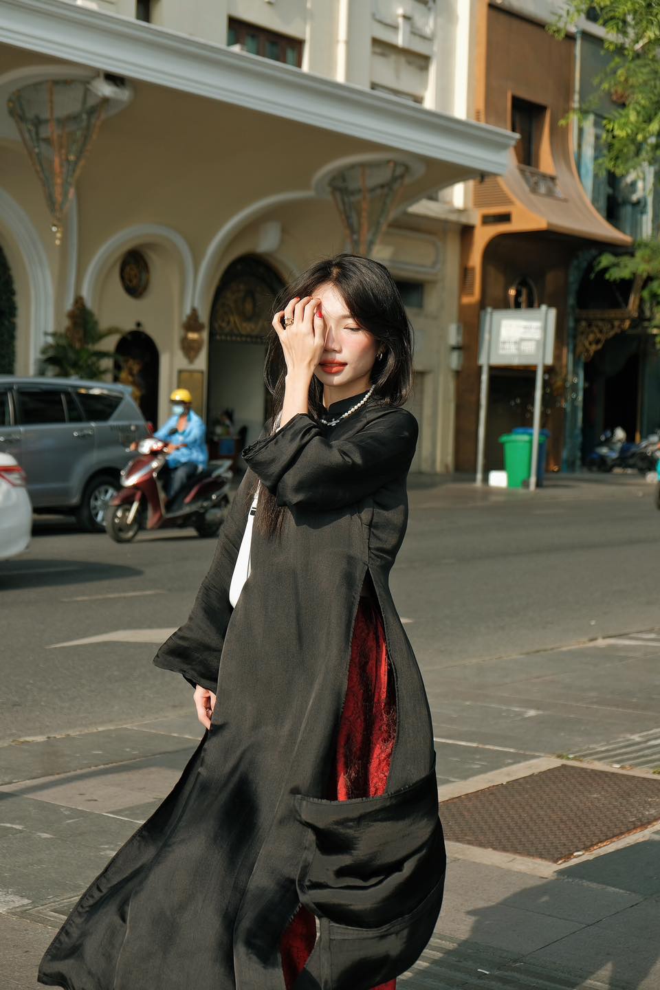 "Traditional Vietnamese Ao dai set in solid black wormsilk with red accents, modern design by Moc."