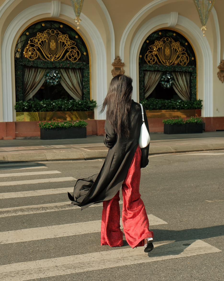 "Traditional Vietnamese Ao dai set 'Huyen Mac' in black silk with red pants, modern artisan design."