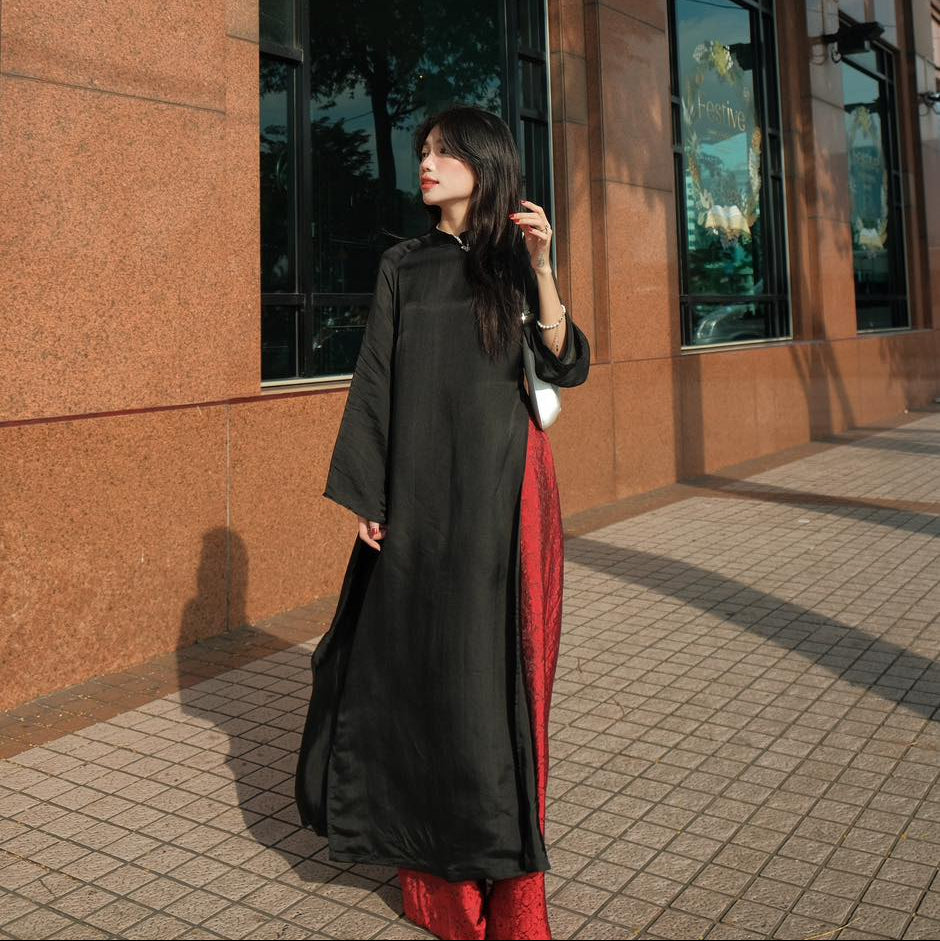 "Traditional Vietnamese Ao dai set 'Huyen Mac' in black silk with red accents, modern artisan design"