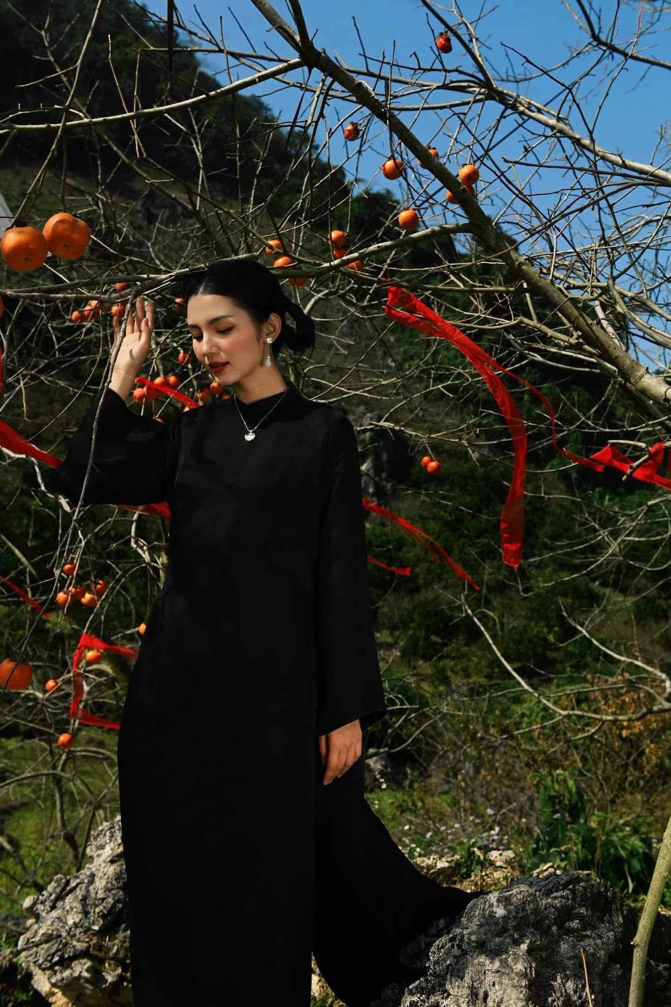 "Traditional Vietnamese Ao dai set 'Huyen Mac' in solid black silk, modern design by Moc."