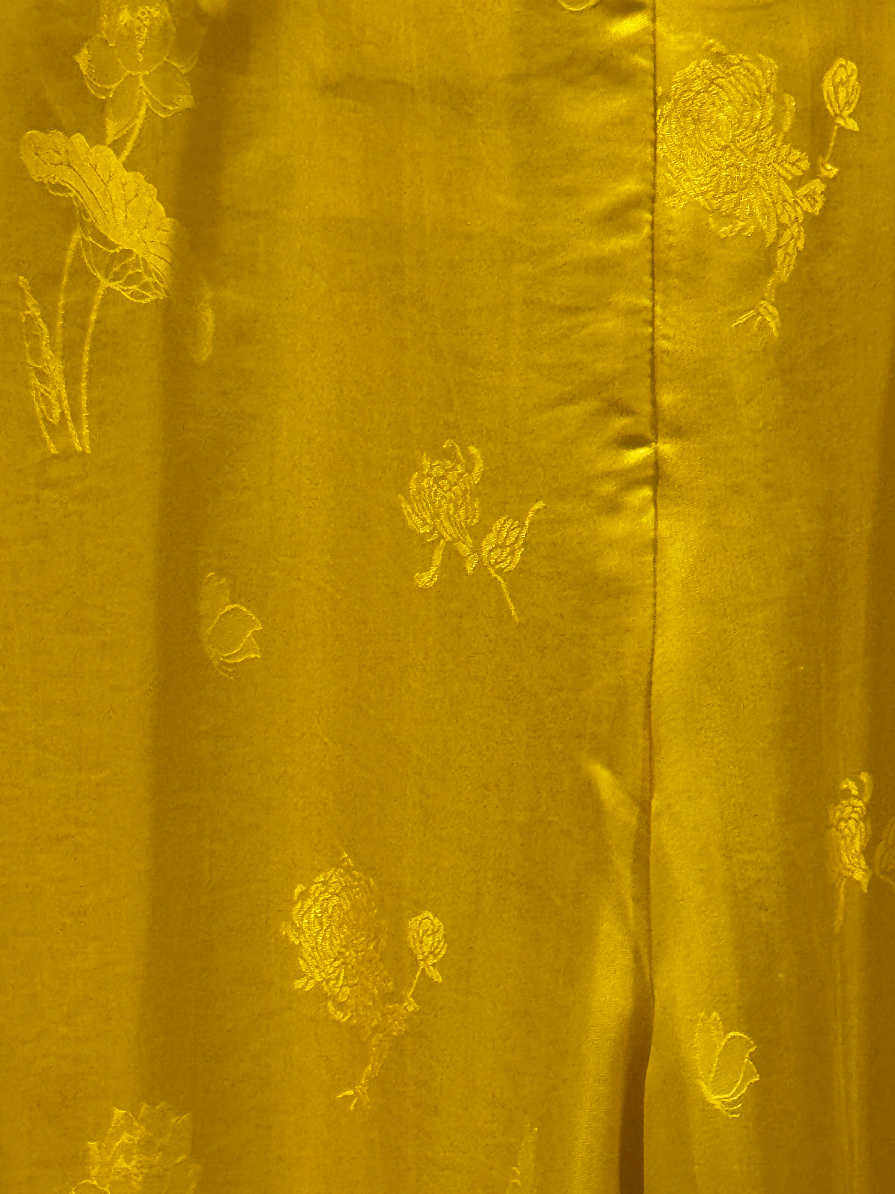 "Lotus pattern Ao Dai pants in yellow woven silk, traditional Vietnamese design by Moc."